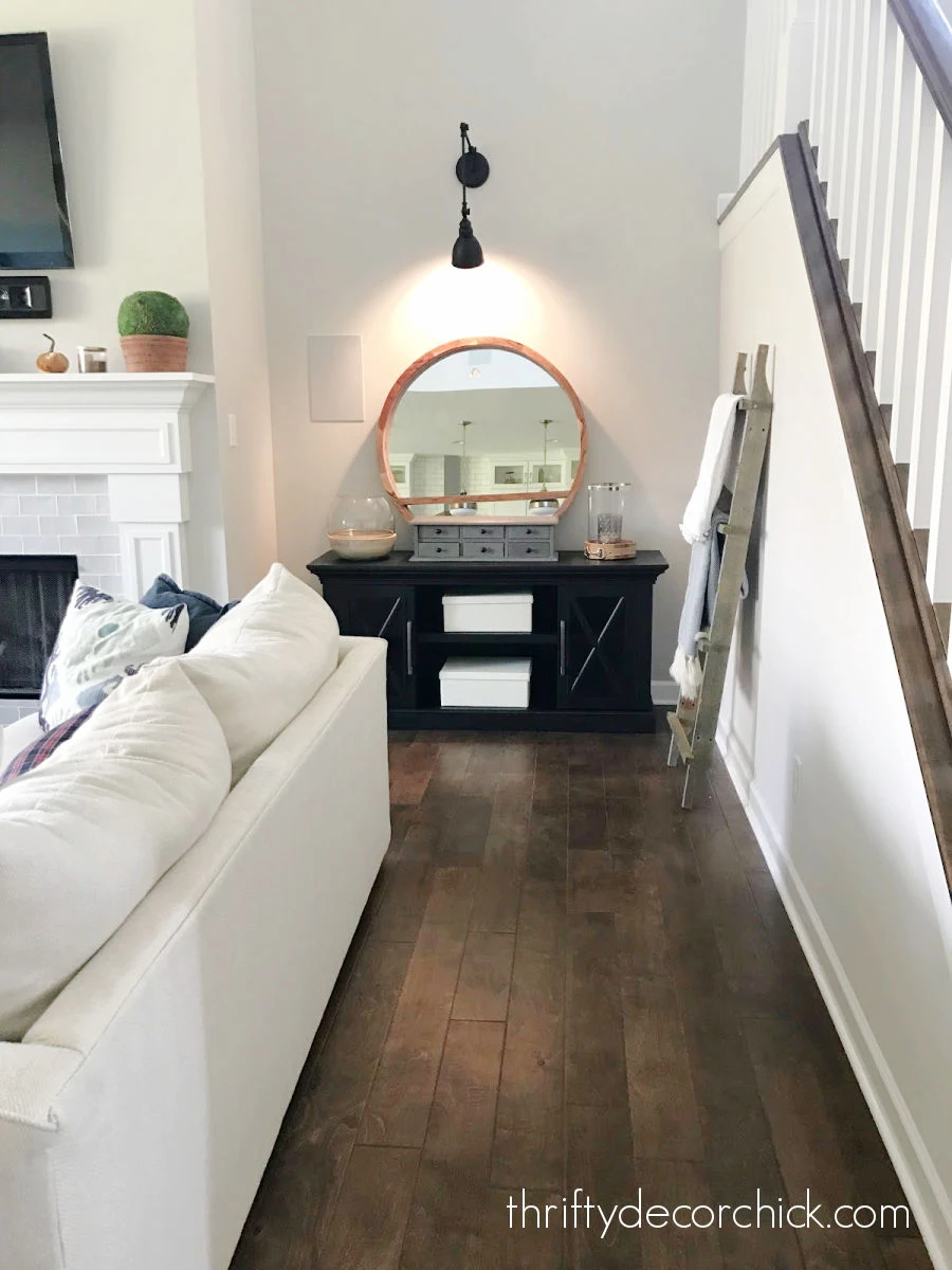 mirrors with sconces next to fireplace