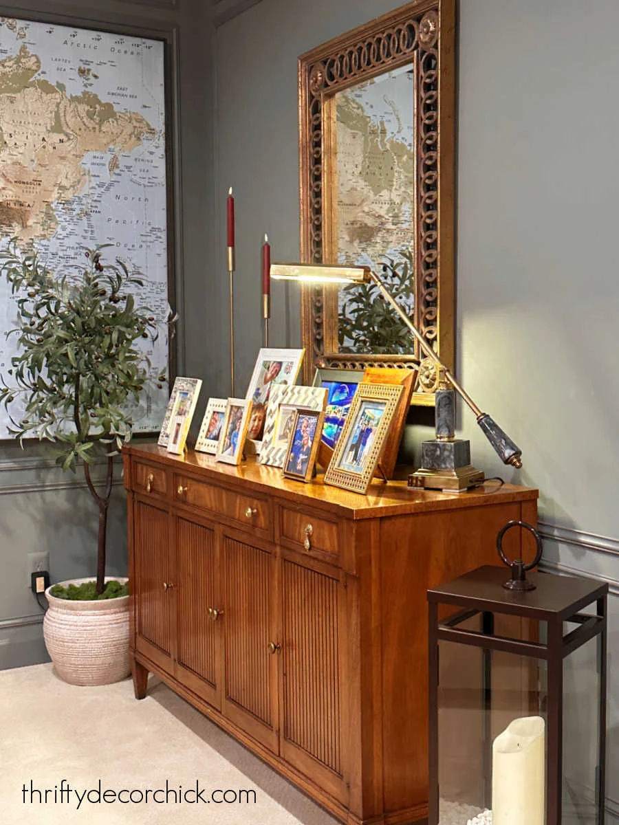 framed photos with lamp on dresser