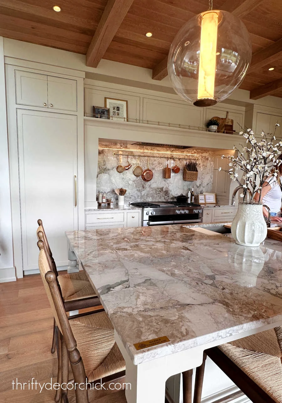 long shelf with tipping rail above stove