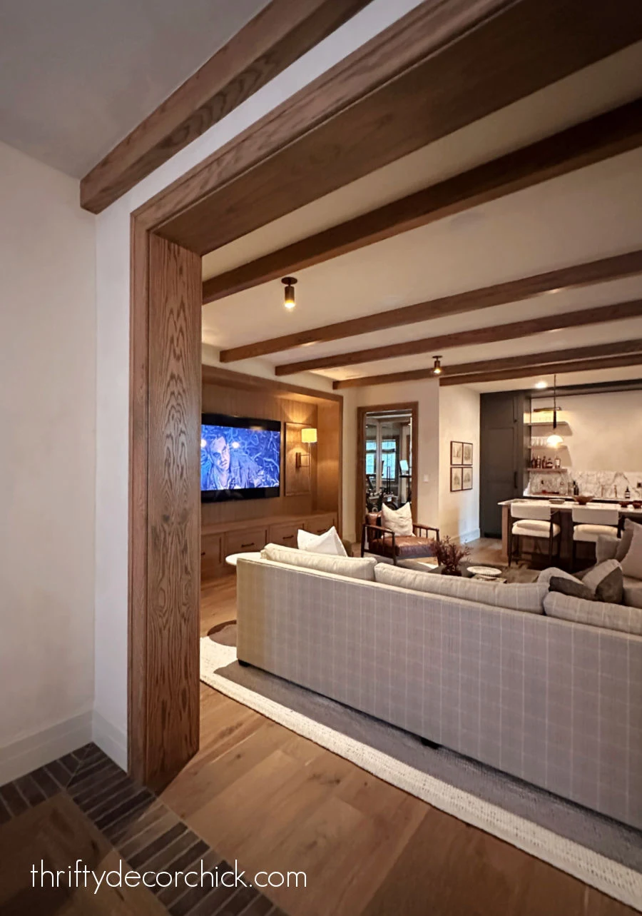 basement living room with wood beams