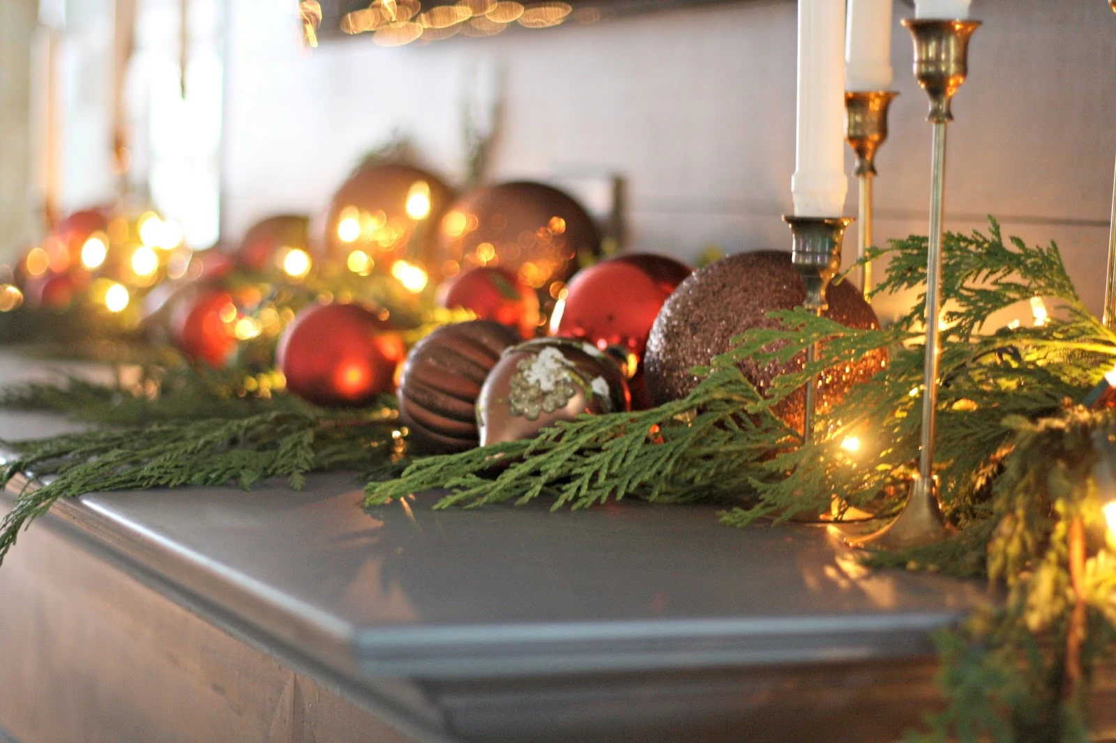 ornaments on mantel greenery